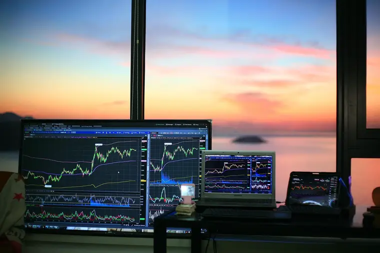 Digital asset market data displayed across multiple screens