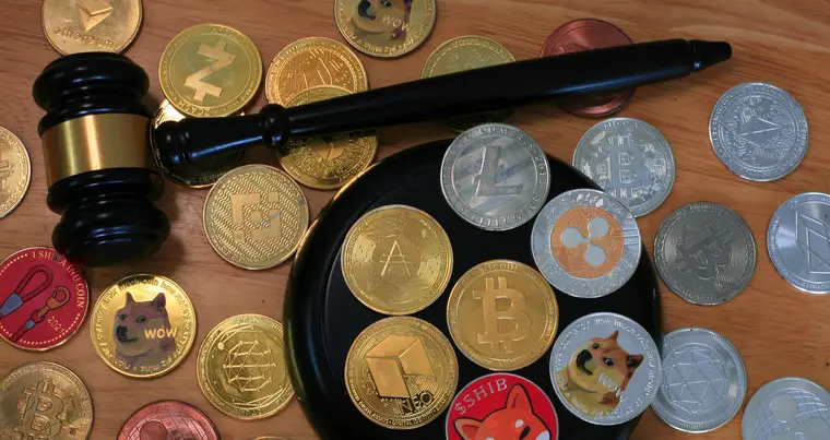 Court documents and a gavel beside a bitcoin token, representing securities litigation